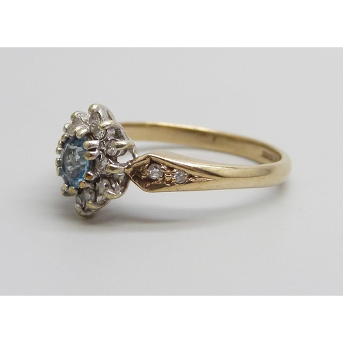 1018 - A 9ct gold aquamarine and diamond cluster ring, 2.8g, P