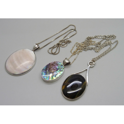 1025 - Three silver stone set pendants and chains