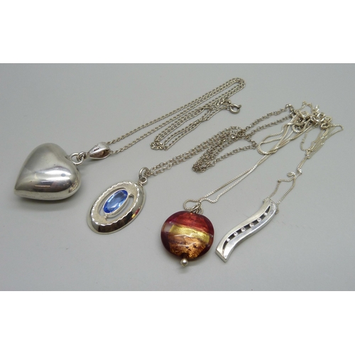 1026 - Four silver pendants and chains