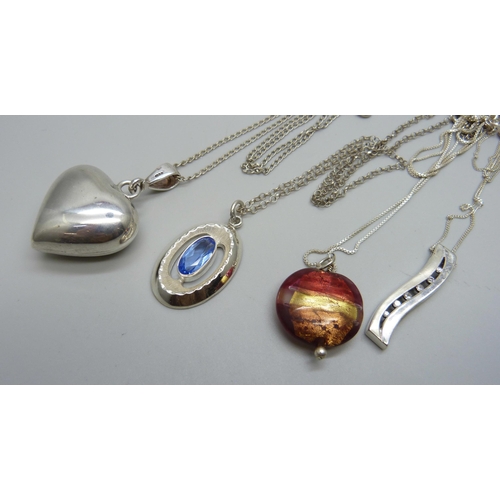 1026 - Four silver pendants and chains