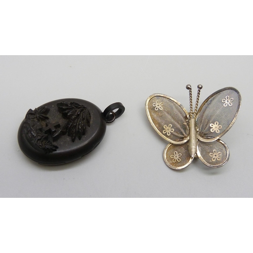 1038 - A carved jet locket and a costume brooch