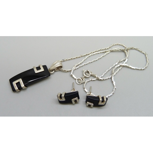 1039 - A sterling silver set pendant on a silver chain with a matching pair of earrings