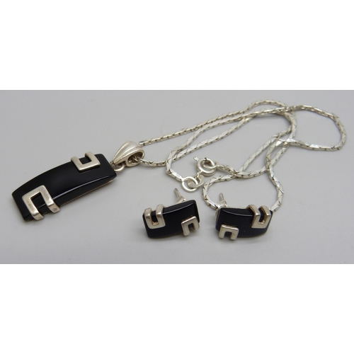 1039 - A sterling silver set pendant on a silver chain with a matching pair of earrings