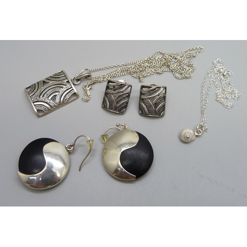 1041 - A sterling silver pendant and chain with a matching pair of earrings and another pair of silver set ... 