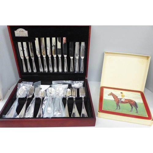 692 - A George Butler canteen of stainless steel cutlery and six horse racing place mats, boxed