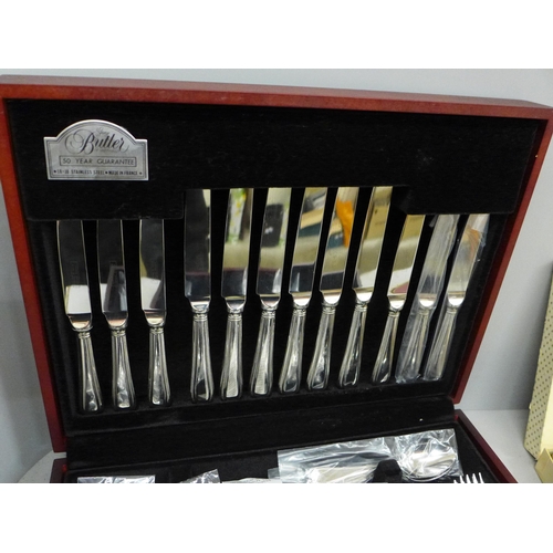 692 - A George Butler canteen of stainless steel cutlery and six horse racing place mats, boxed