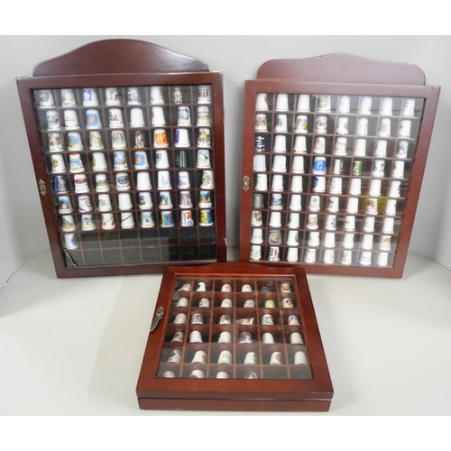 1077 - A large collection of thimbles displayed in three small cabinets with  a collection of bone china an... 