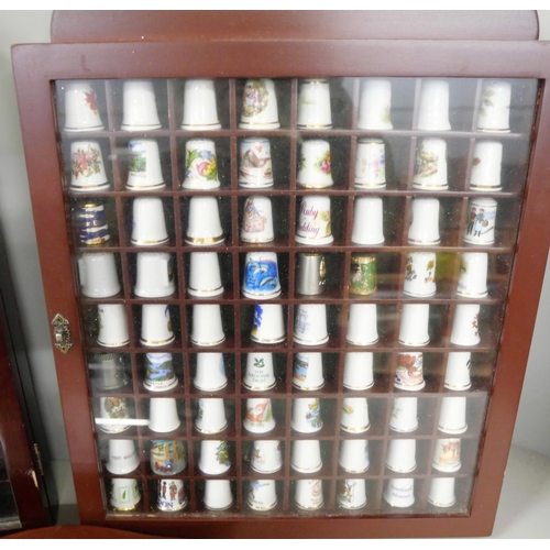 1077 - A large collection of thimbles displayed in three small cabinets with  a collection of bone china an... 