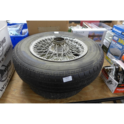 5295 - A steel wire wheel and part worn tyre (suspected MGB GT wheel) and a steel space saver wheel with pa... 