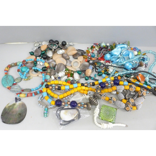 719 - A collection of glass bead and stone jewellery including shells and pearls