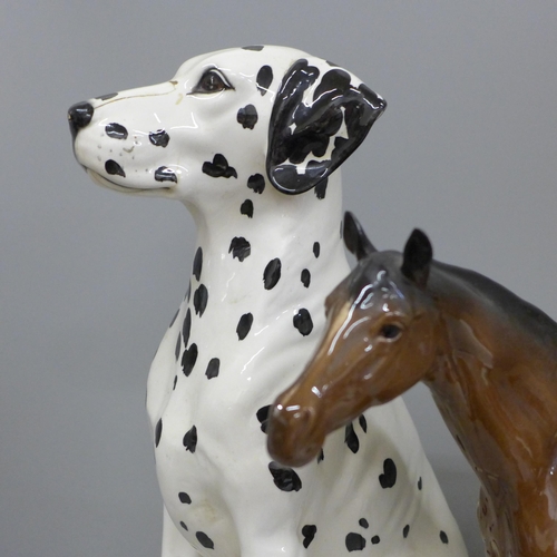 606 - Two Beswick figures, dalmatian, damage to nose and a large racehorse, one ear restored