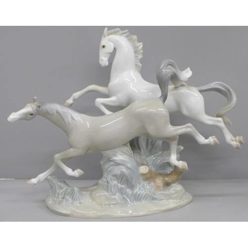 608 - A large Lladro figure group, two Galloping Horses, 37cm