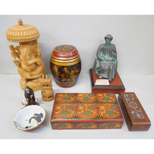 790 - A bronzed seated Arab figure, decorative wooden boxes, wooden figure of Ganesh and a small china bow... 