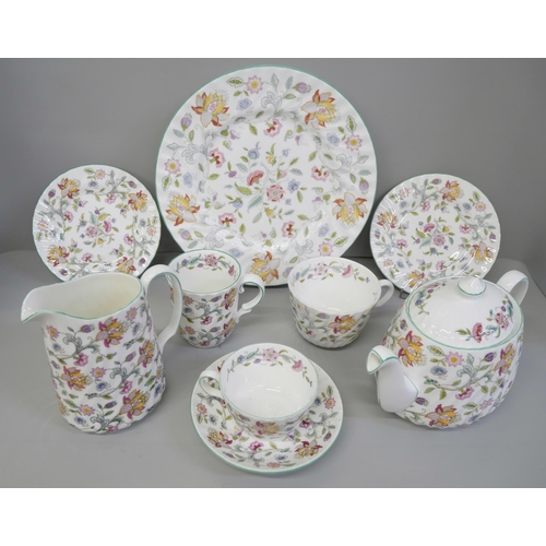 795 - A Minton Haddon Hall dinner and tea service including twelve dinner, tea and side plates, some piece... 