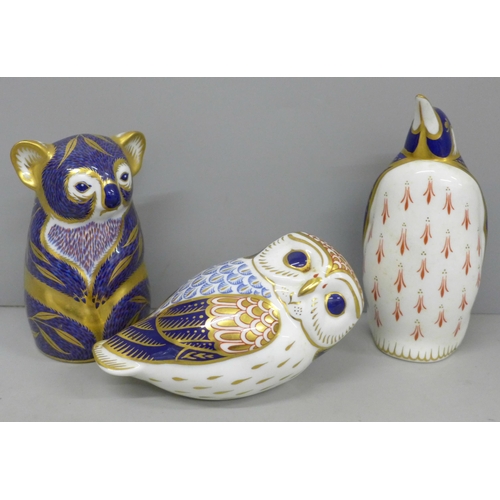 638 - Three Royal Crown Derby paperweights, owl, koala and penguin, tow gold and one silver stopper