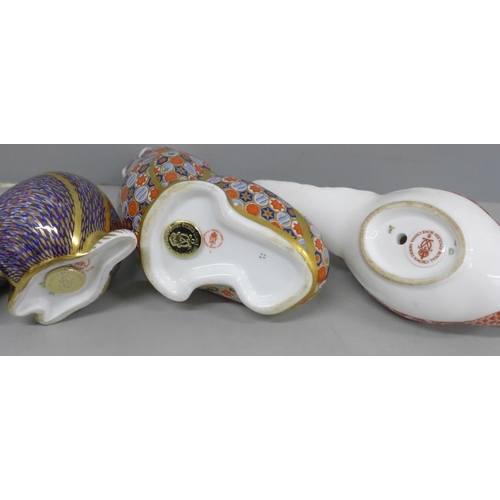 639 - Three Royal Crown Derby paperweights, partridge, badger and walrus, two with gold stoppers