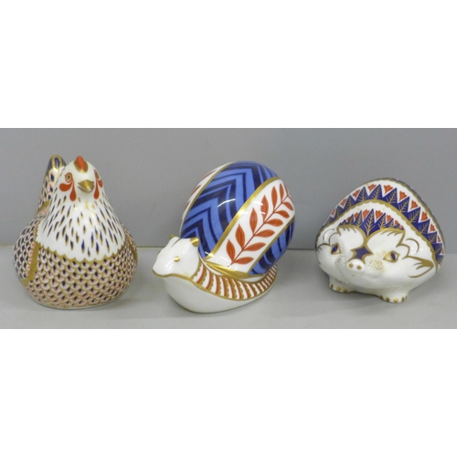 640 - Three Royal Crown Derby paperweights, snail, hen and hedgehog