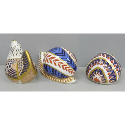 640 - Three Royal Crown Derby paperweights, snail, hen and hedgehog