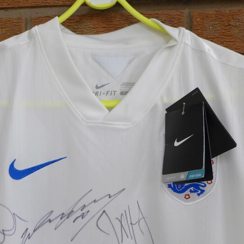 826 - An England football shirt, 2014, signed by the team