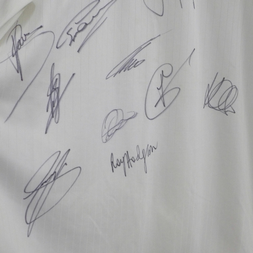 826 - An England football shirt, 2014, signed by the team