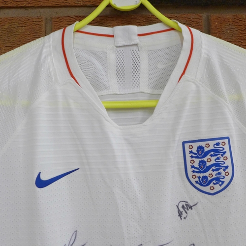 831 - A lady's England football shirt, signed by the team, 2018