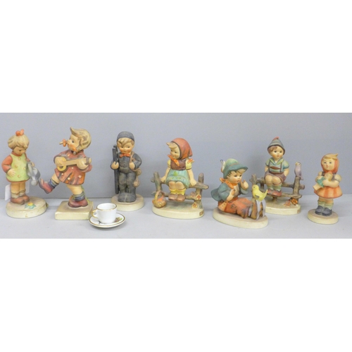 655 - Seven Goebel figures and a miniature cup and saucer