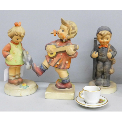 655 - Seven Goebel figures and a miniature cup and saucer