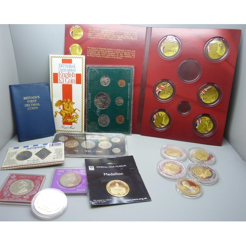 846 - A collection of coin packs including 1987 uncirculated English £1 coin, a medallion, Imperial War Mu... 