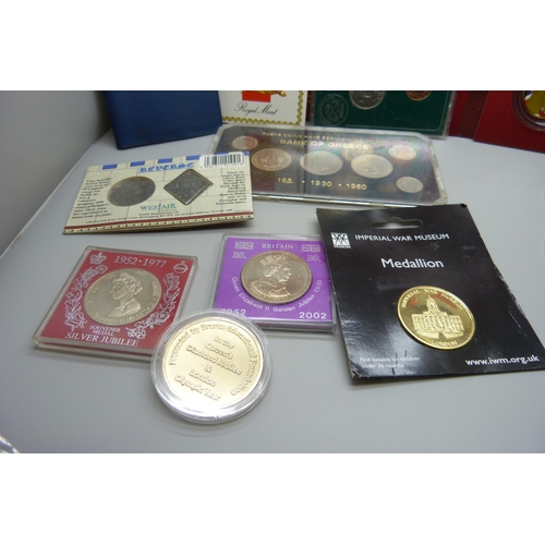 846 - A collection of coin packs including 1987 uncirculated English £1 coin, a medallion, Imperial War Mu... 