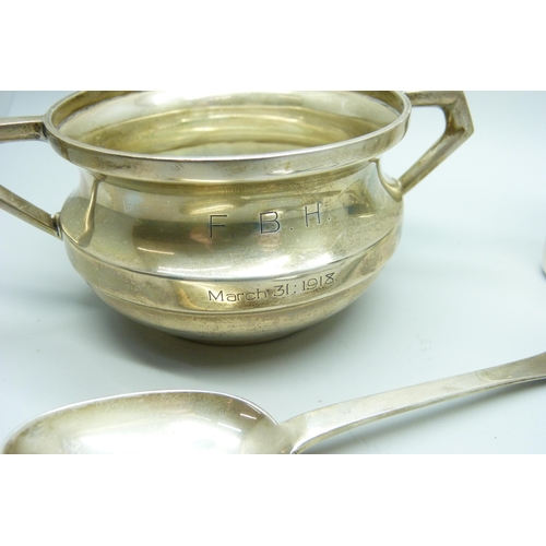 863 - A silver bowl, a silver flask cup and two silver spoons, 238g