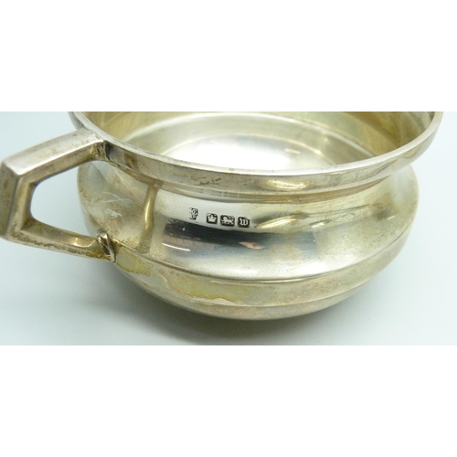 863 - A silver bowl, a silver flask cup and two silver spoons, 238g