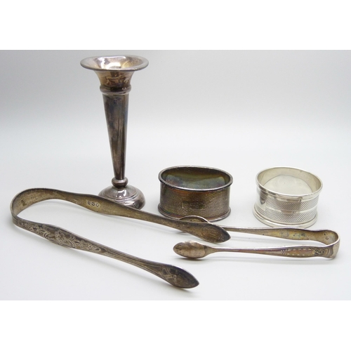 868 - Two pairs of silver sugar bows and two silver napkin rings, 78g, and a silver posy vase