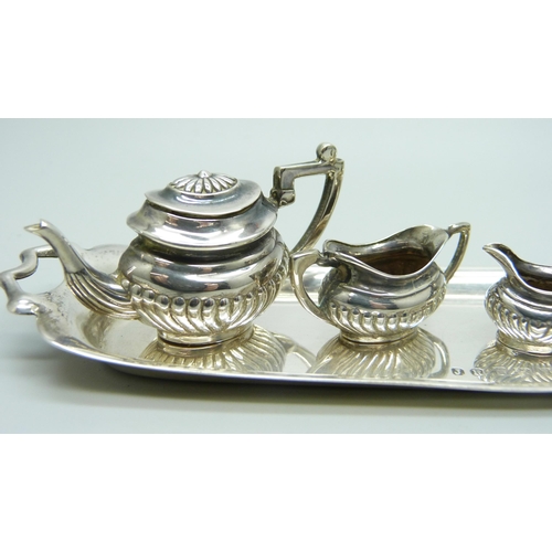 869 - A hallmarked silver miniature doll's house tea service and tray, 66g, tray 14.5cm