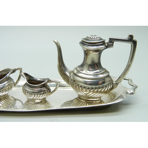 869 - A hallmarked silver miniature doll's house tea service and tray, 66g, tray 14.5cm