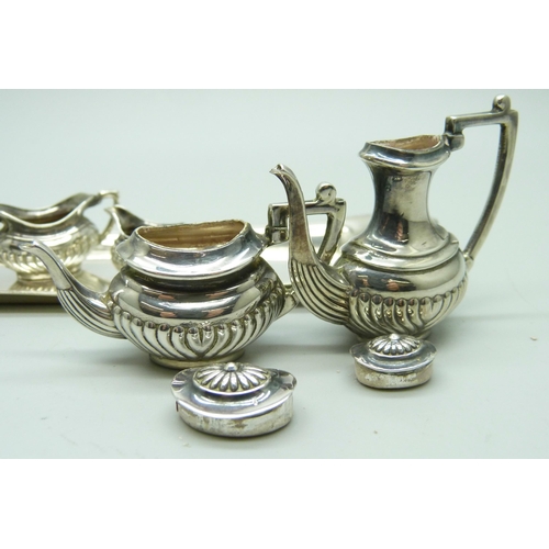 869 - A hallmarked silver miniature doll's house tea service and tray, 66g, tray 14.5cm