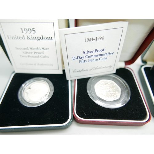 884 - Four silver proof coins including WWII 60th Anniversary and DNA Double Helix Discovery, with certifi... 