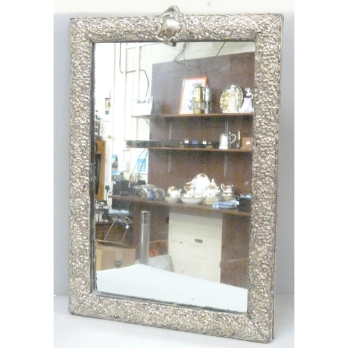 886 - A silver framed mirror, no back stand, 32cm wide, lacking small piece of silver from the top