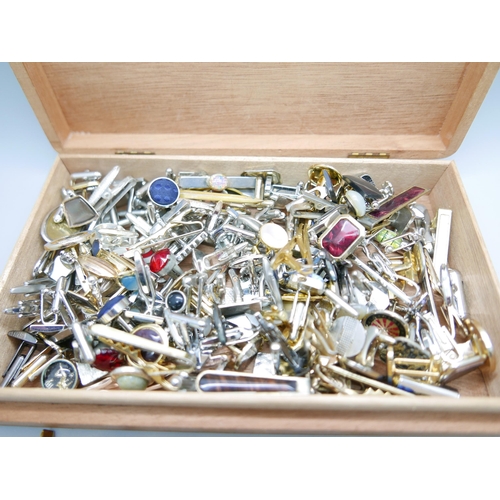 892 - A collection of cufflinks, approximately 52 pairs and 29 tie-pins