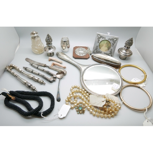 925 - A silver hand mirror, a silver mounted nail buffer, two nut crackers, jewellery, etc.