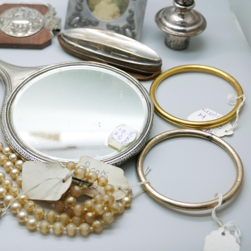 925 - A silver hand mirror, a silver mounted nail buffer, two nut crackers, jewellery, etc.