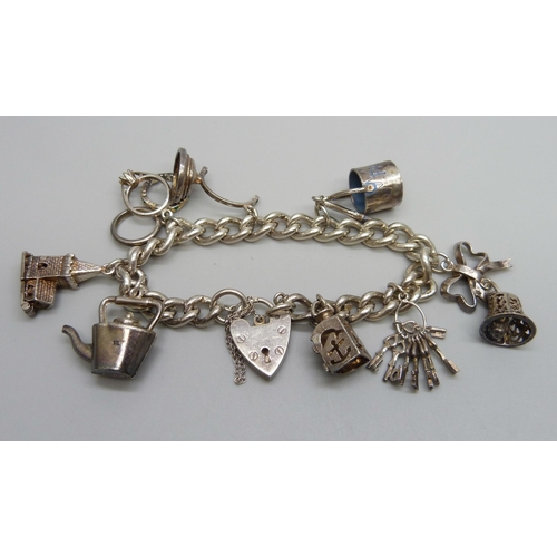 927 - A silver charm bracelet, 50g, two charms a/f