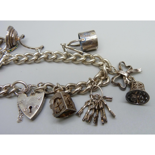 927 - A silver charm bracelet, 50g, two charms a/f