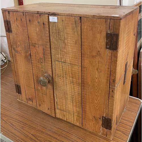 202 - A pine wall hanging cupboard made from ammunition cases