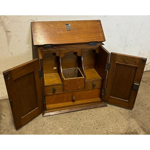 216 - A late Victorian carved oak smokers cabinet