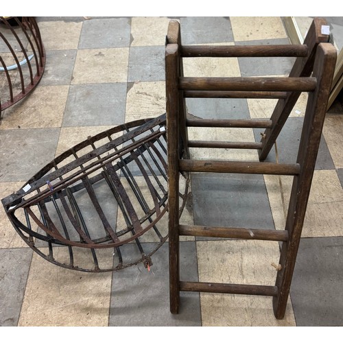 235 - Three cast iron hay racks and a pine stepladder