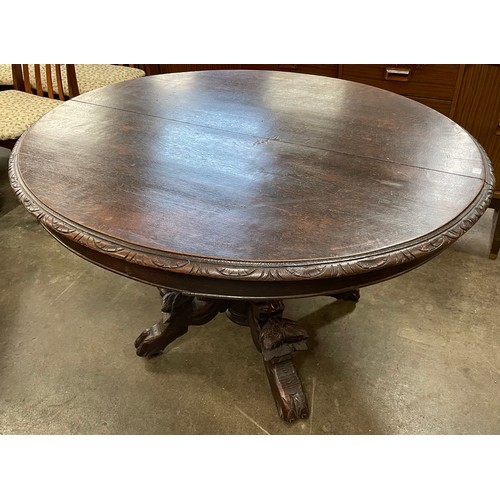 101A - A Victorian carved oak oval dining table