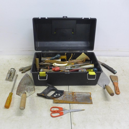 5036 - A black plastic toolbox with tools including saws, screw drivers, trowels, a tape measure, etc.