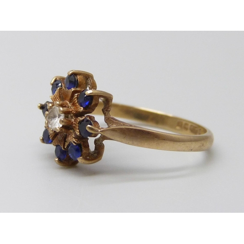 7002 - A 9ct gold, sapphire and white stone cluster ring, 1.9g, K/L