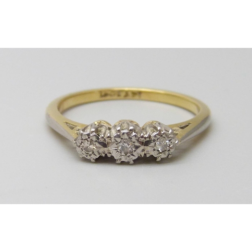 7005 - An 18ct gold and platinum three stone diamond ring, 2.5g, L