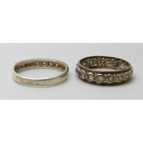 7008 - A 9ct gold and silver ring, N, and an unmarked eternity ring, J/K, 3.9g total